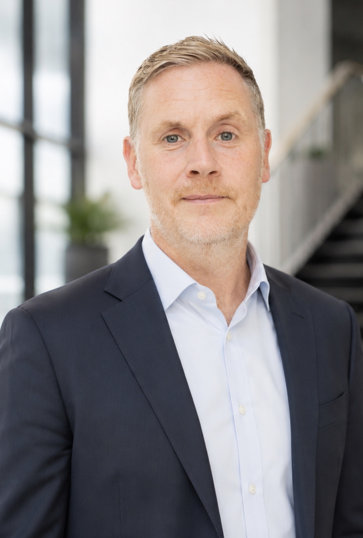 Gareth Squance, co-founder of Orca Health, wearing a navy suit.
